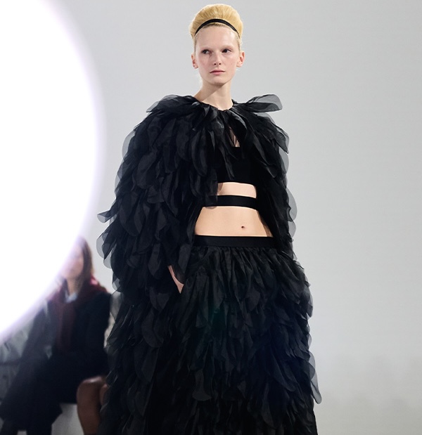 Max Mara Spring/Summer 2026 Fashion Show - Frame showing model on the runway with Black Look with Jacket and Skirt with detailing.